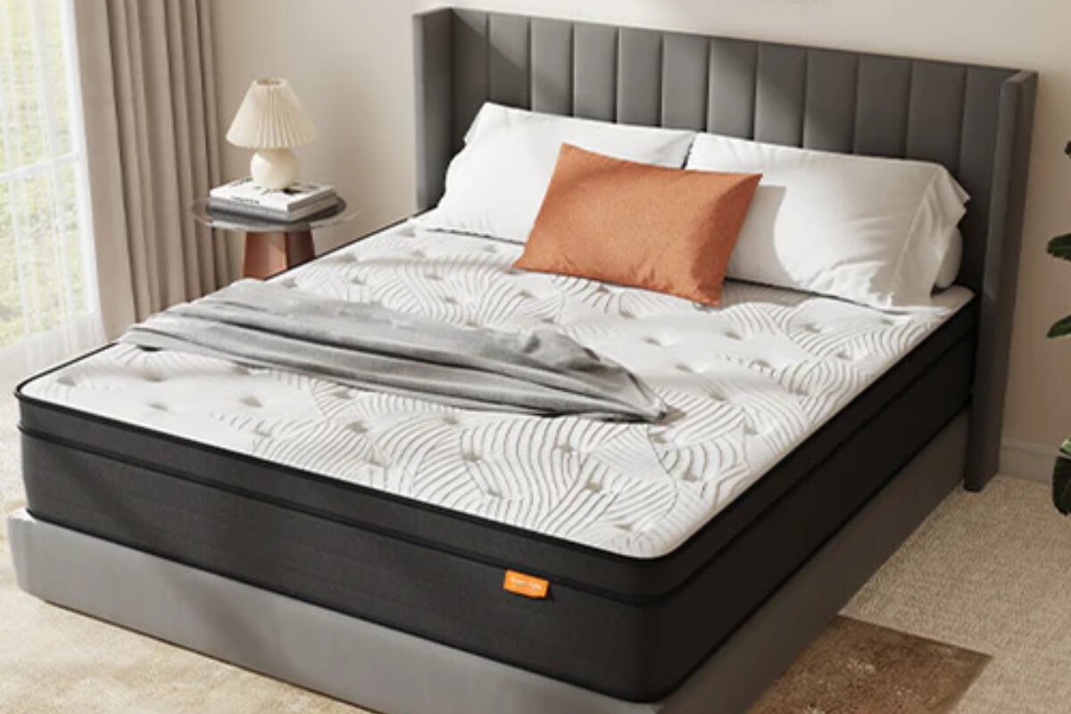 The SweetNight Twilight Hybrid Mattress with pillows and a blanket.