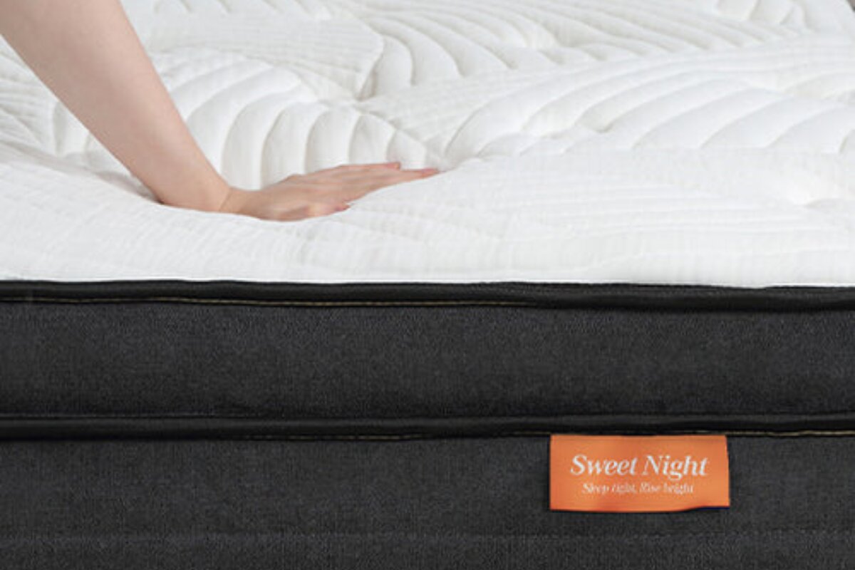 A person pressing on the SweetNight Twilight Hybrid Mattress.
