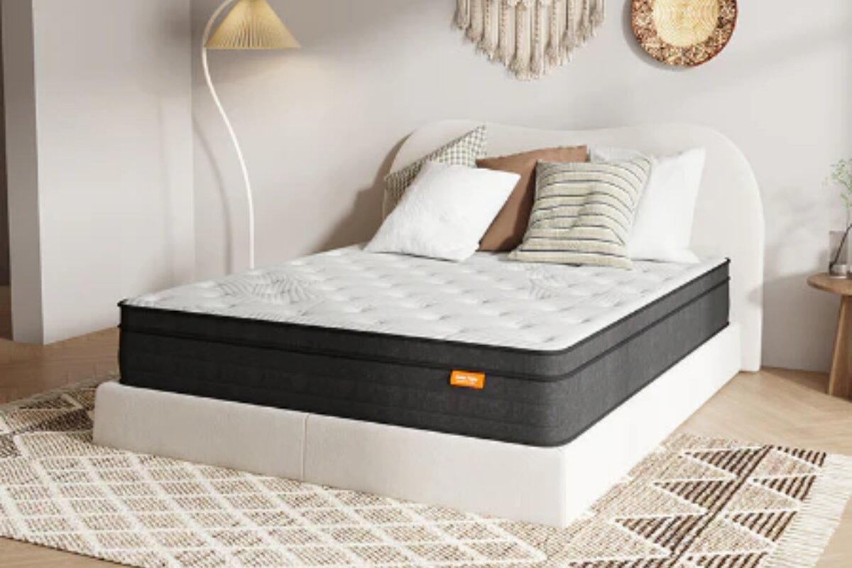 The SweetNight Twilight Hybrid Mattress on a bedframe with pillows.