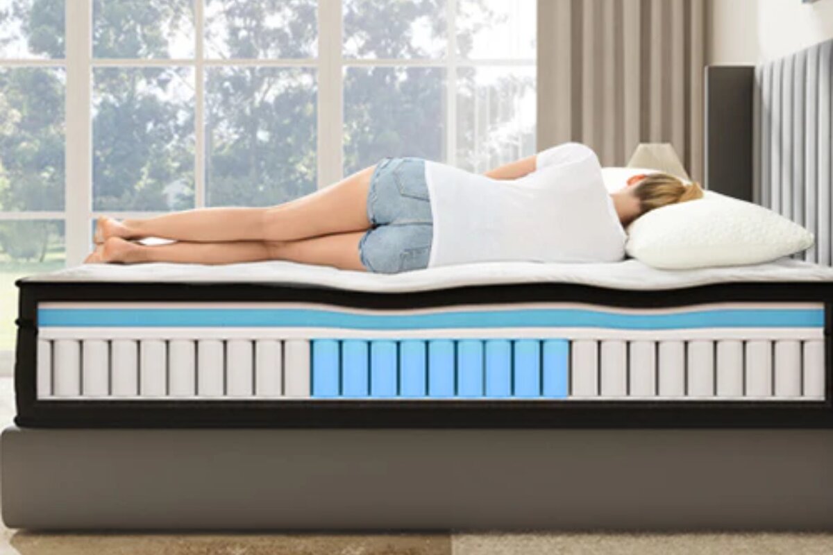 A woman sleeping on the SweetNight Twilight Hybrid Mattress with the layers exposed.