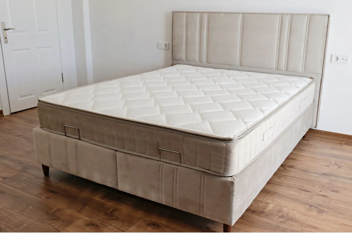 Traditional innerspring mattress on a bed base, demonstrating the classic coil-supported design used in standard innerspring mattresses