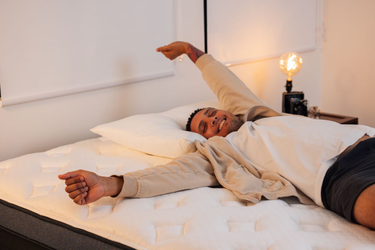 A man stretching on the the Helix Midnight Luxe.