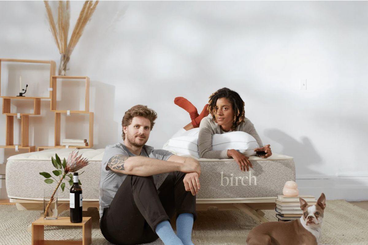Couple relaxing on a Birch Natural Mattress with their dog, representing real customer experiences and overall satisfaction with the mattress