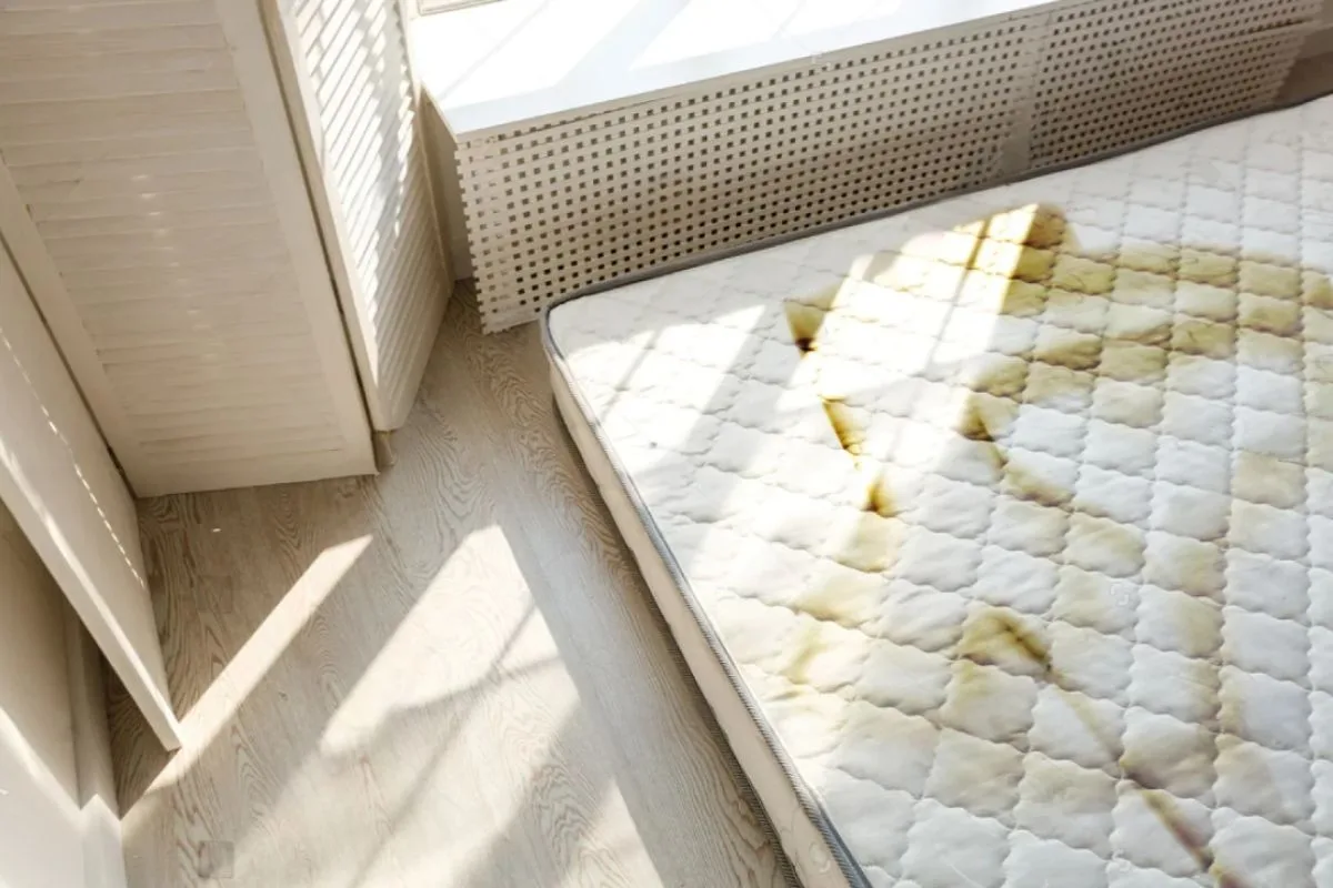 Stained and discolored mattress surface, showing visible damage and hygiene concerns that may signal it's time for a new memory foam mattress