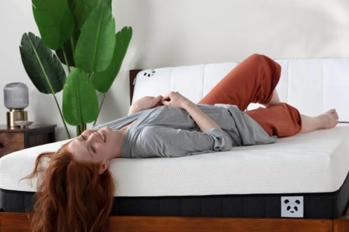 A woman lying down on the Panda Hybrid Bamboo Mattress Pro.