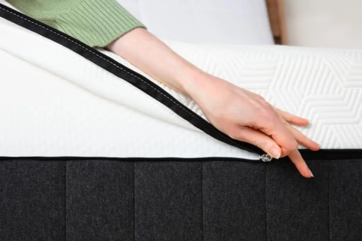 A person unzipping the Panda Hybrid Bamboo Mattress Pro.