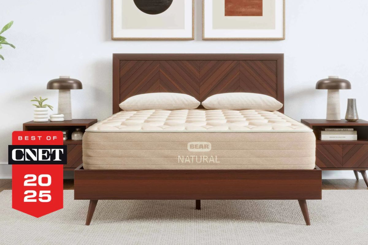Bear Natural mattress displayed in a bedroom with a CNET award badge, illustrating a premium natural mattress featured in discussions of customer complaints and real user experiences