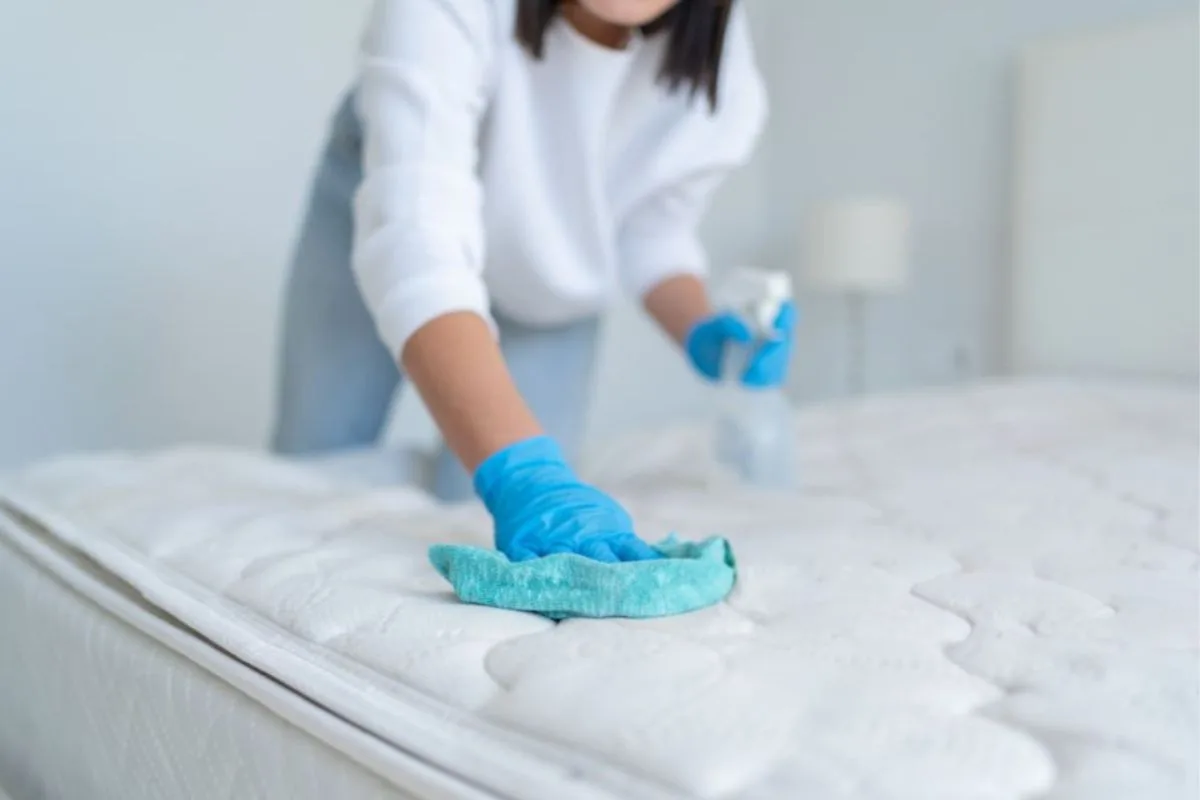 How to Clean a Latex Mattress? Wiping down a latex mattress with a soft cloth and gentle cleaner for safe surface cleaning