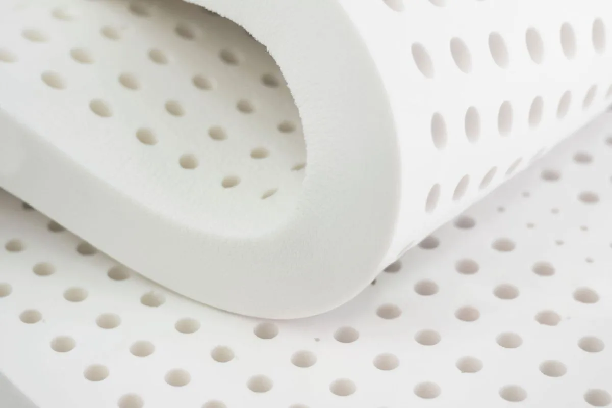 What Is the Difference Between Foam and Latex Mattress? Close-up of perforated latex foam showing the breathable structure that helps regulate temperature in latex mattresses