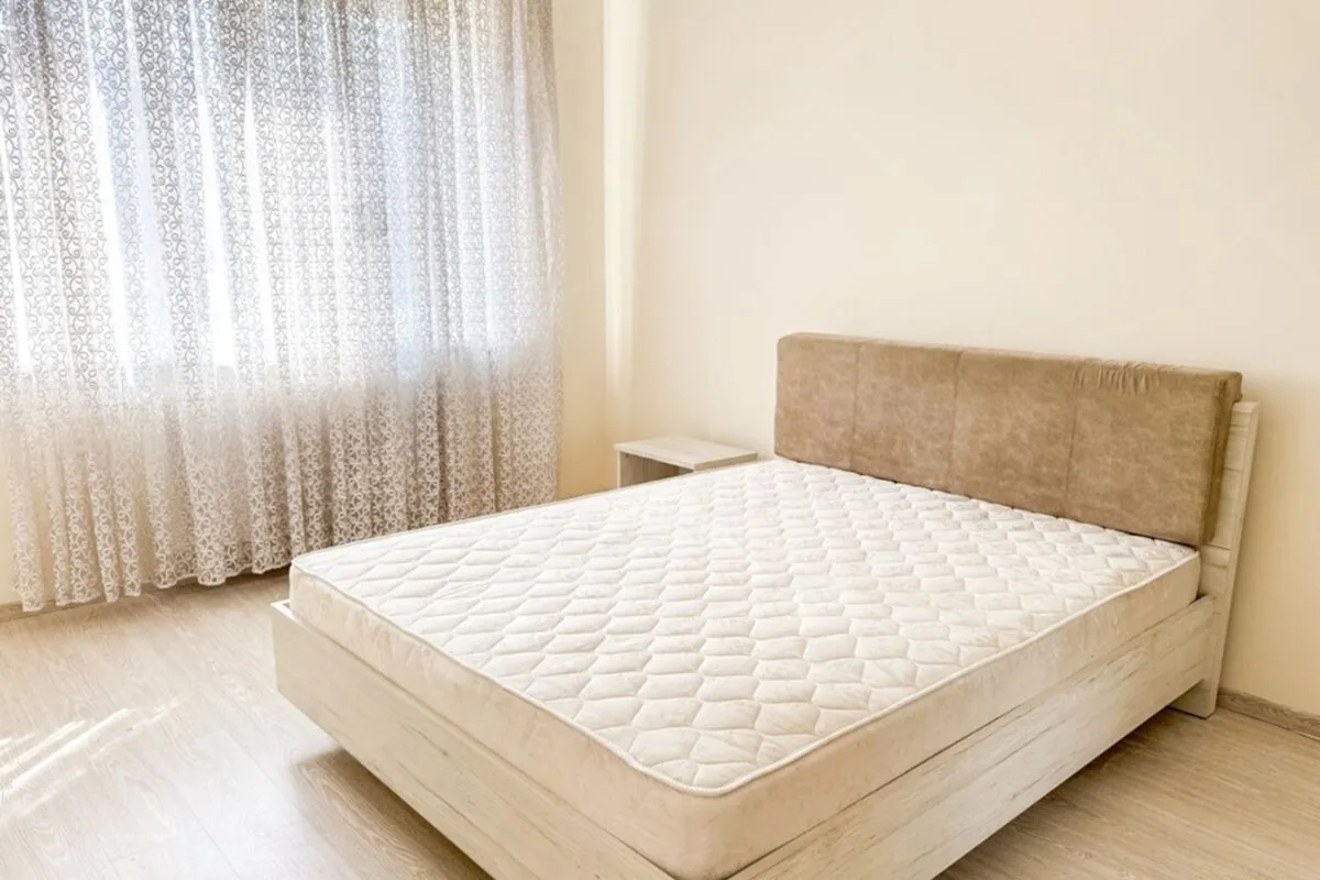 Are Adjustable Firmness Mattresses Good? A bed in a well-lit room.