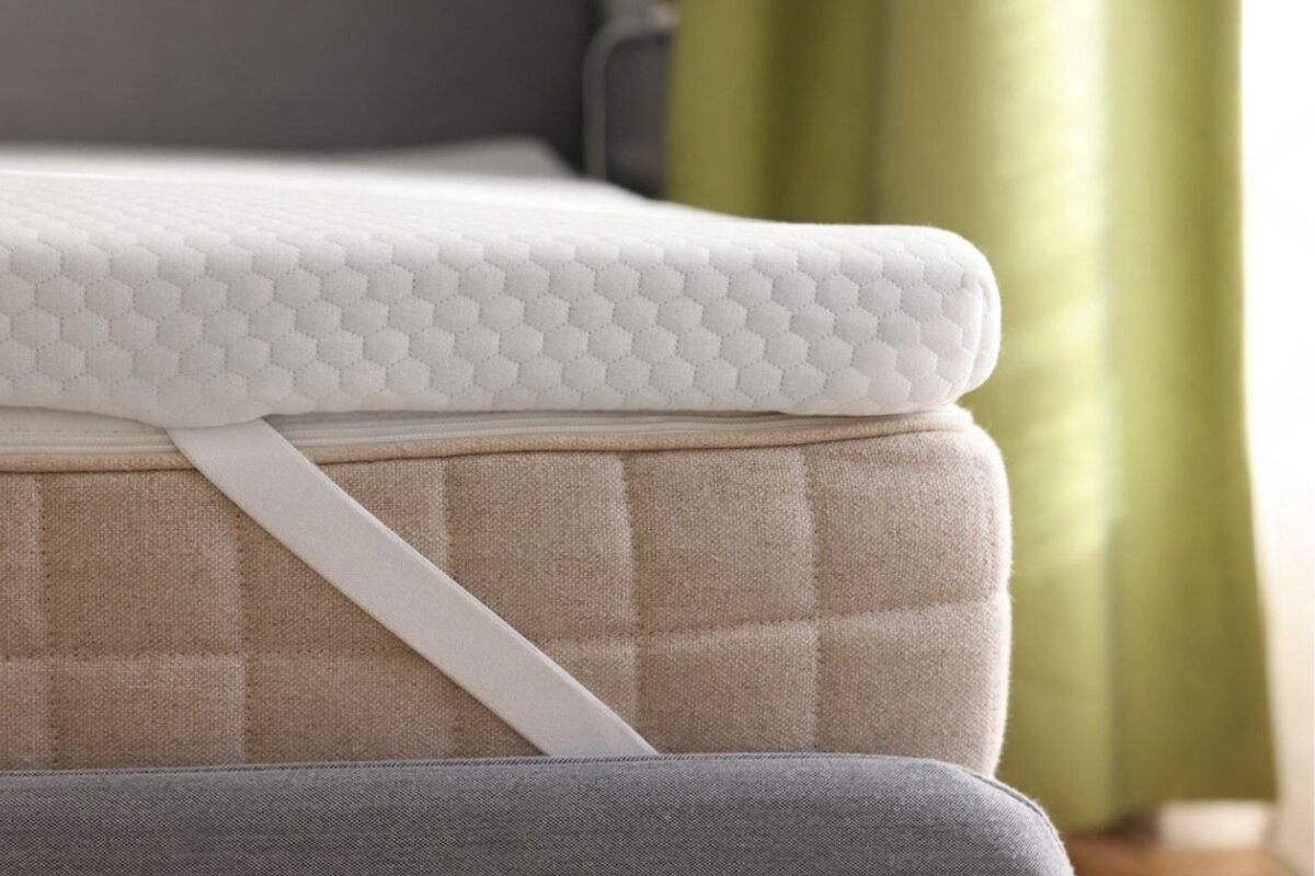 A mattress with a mattress topper.