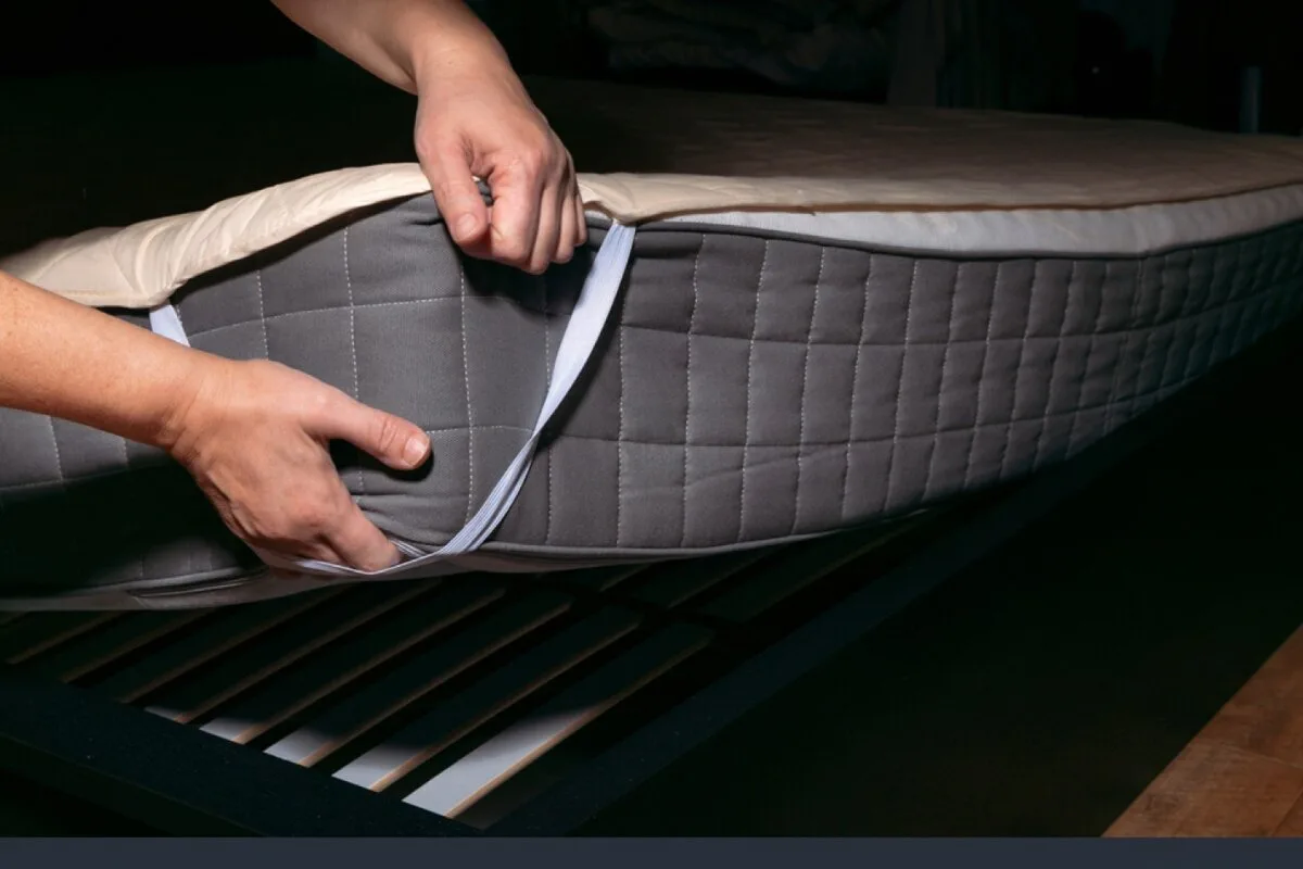 How to Make a Latex Hybrid Mattress Softer? A person putting on a mattress cover.