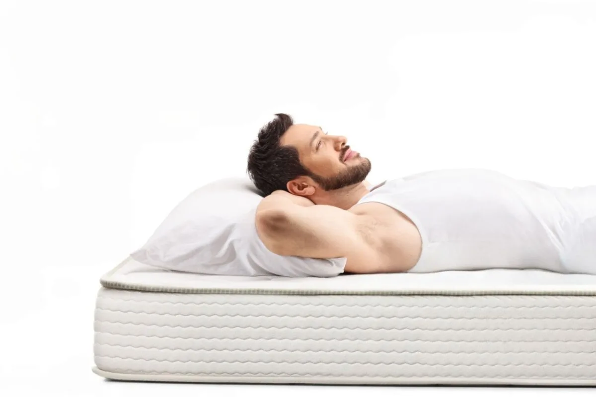 A man lying down on a bed.