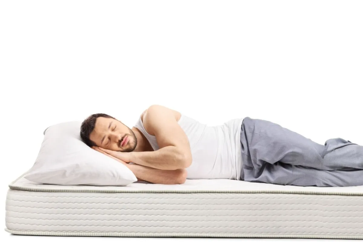 A man sleeping on their side.