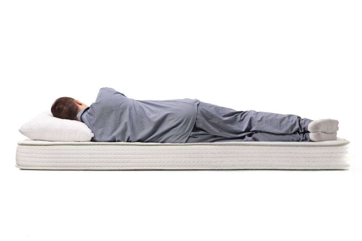 A man sleeping on a bed.