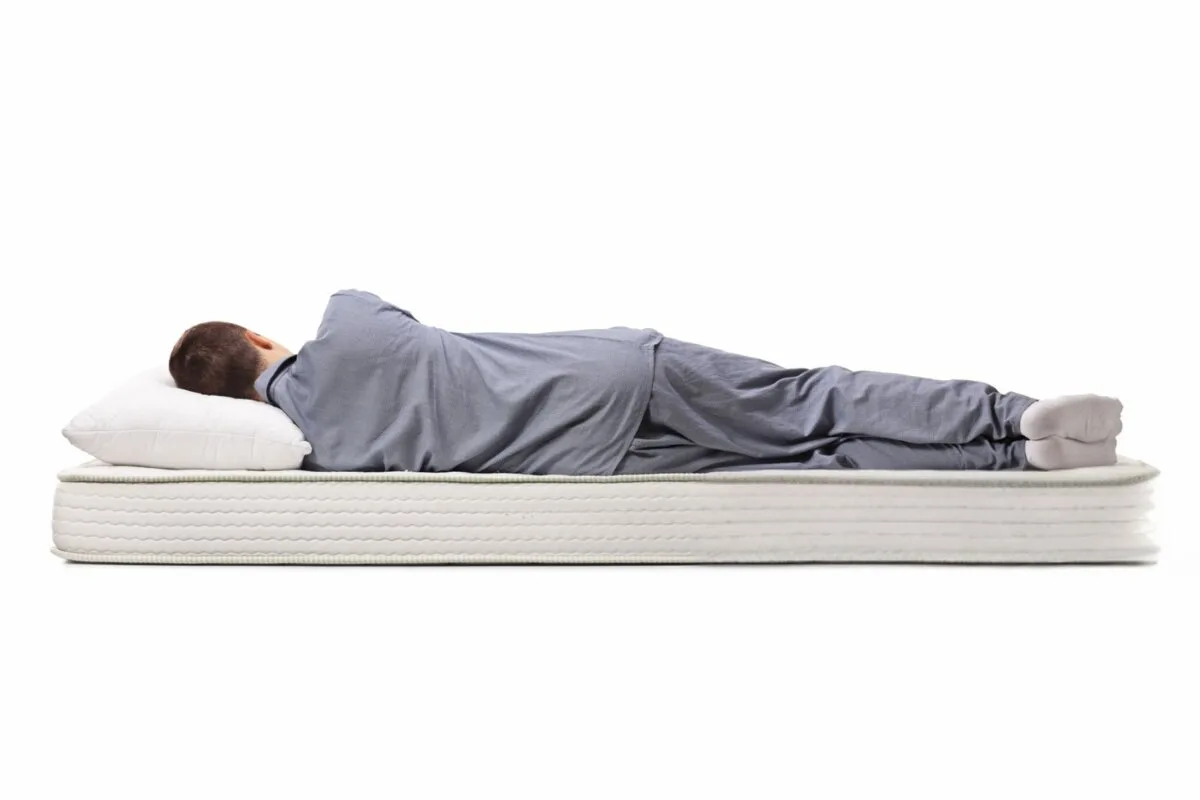 A man sleeping on a bed.