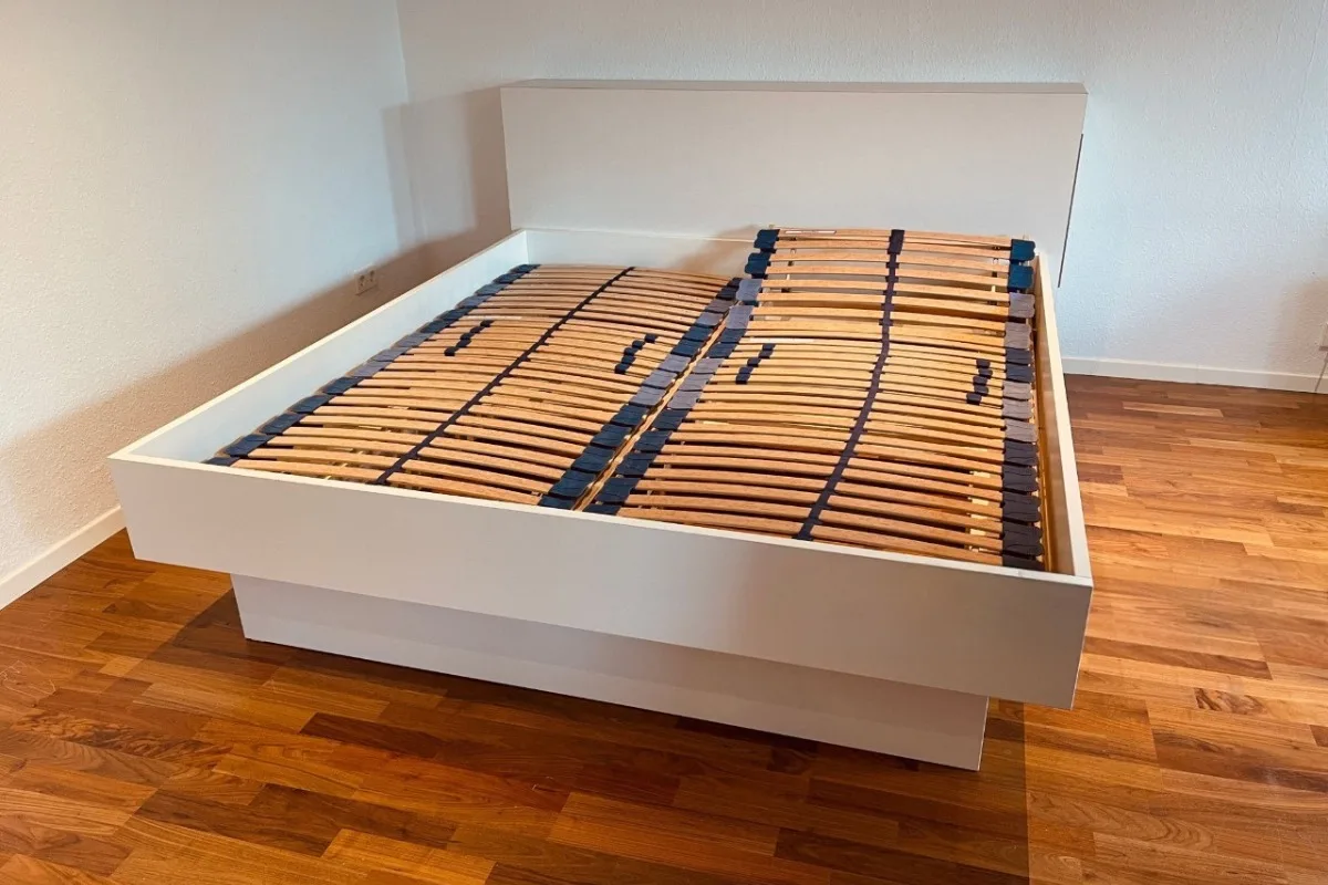 Can You Put An Adjustable Firmness Mattress On Any Bed? An empty bedframe with close slats.