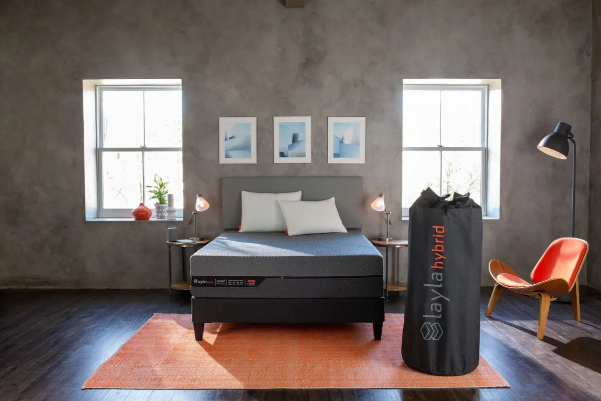 Layla Hybrid Mattress in a bedroom with its mattress bag, illustrating the convenient mattress-in-a-box delivery and in-home trial experience