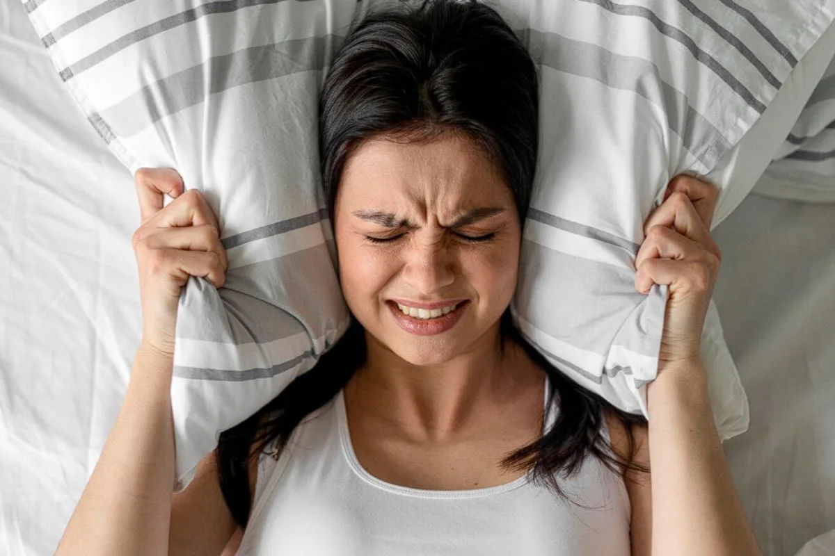 What Are The Disadvantages Of An Adjustable Firmness Mattress? Sleeper experiencing discomfort, representing one of the potential disadvantages of choosing the wrong adjustable firmness mattress settings