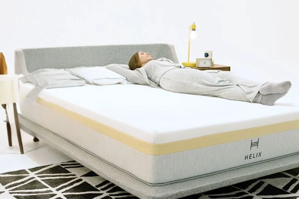 Sleeper lying on the Helix Dawn Mattress to demonstrate its firm feel and support based on real customer experiences