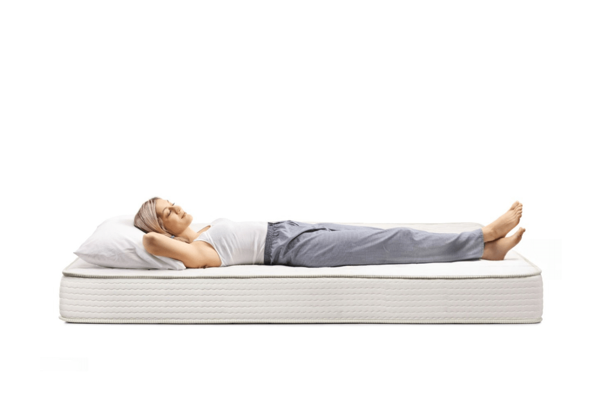 A woman lying down in bed.