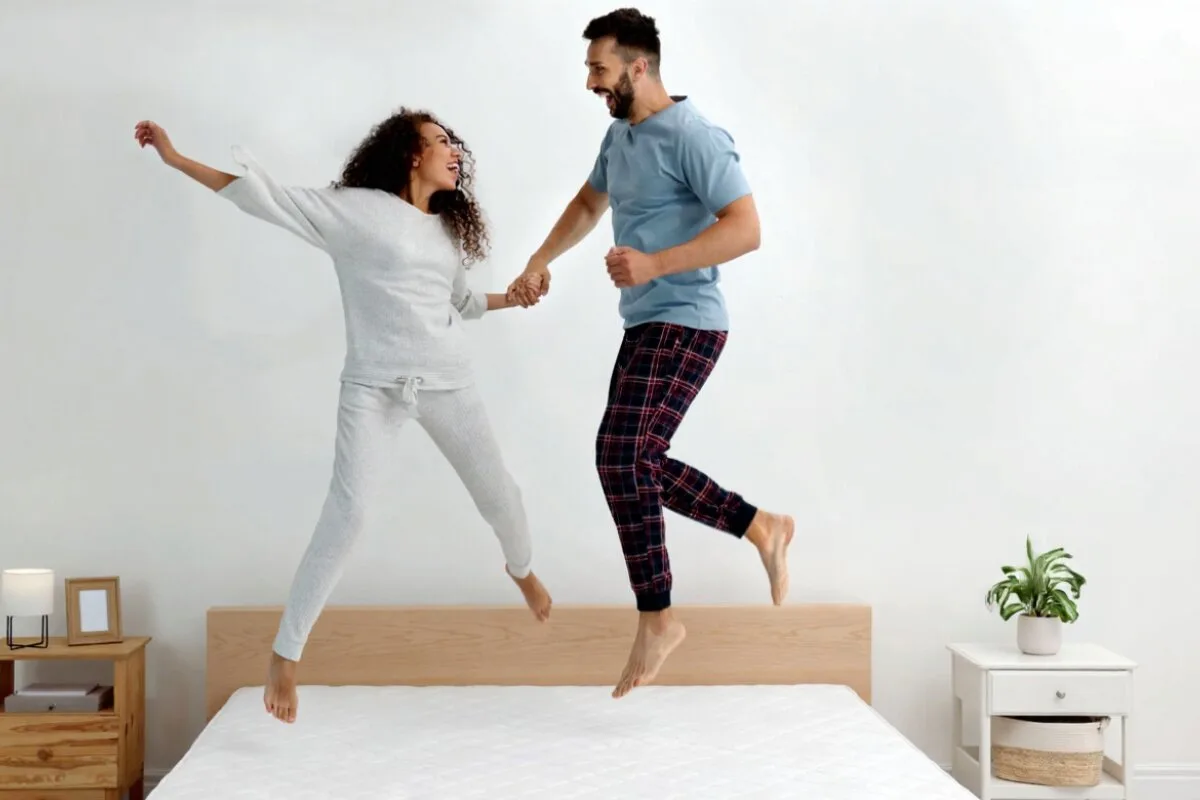 How Should Combination Sleepers Sleep for Optimal Comfort? A couple jumping on a mattress.