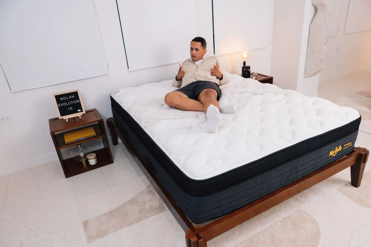 A man wearing comfortable clothes legs stretched out on a Nolah Evolution 15".