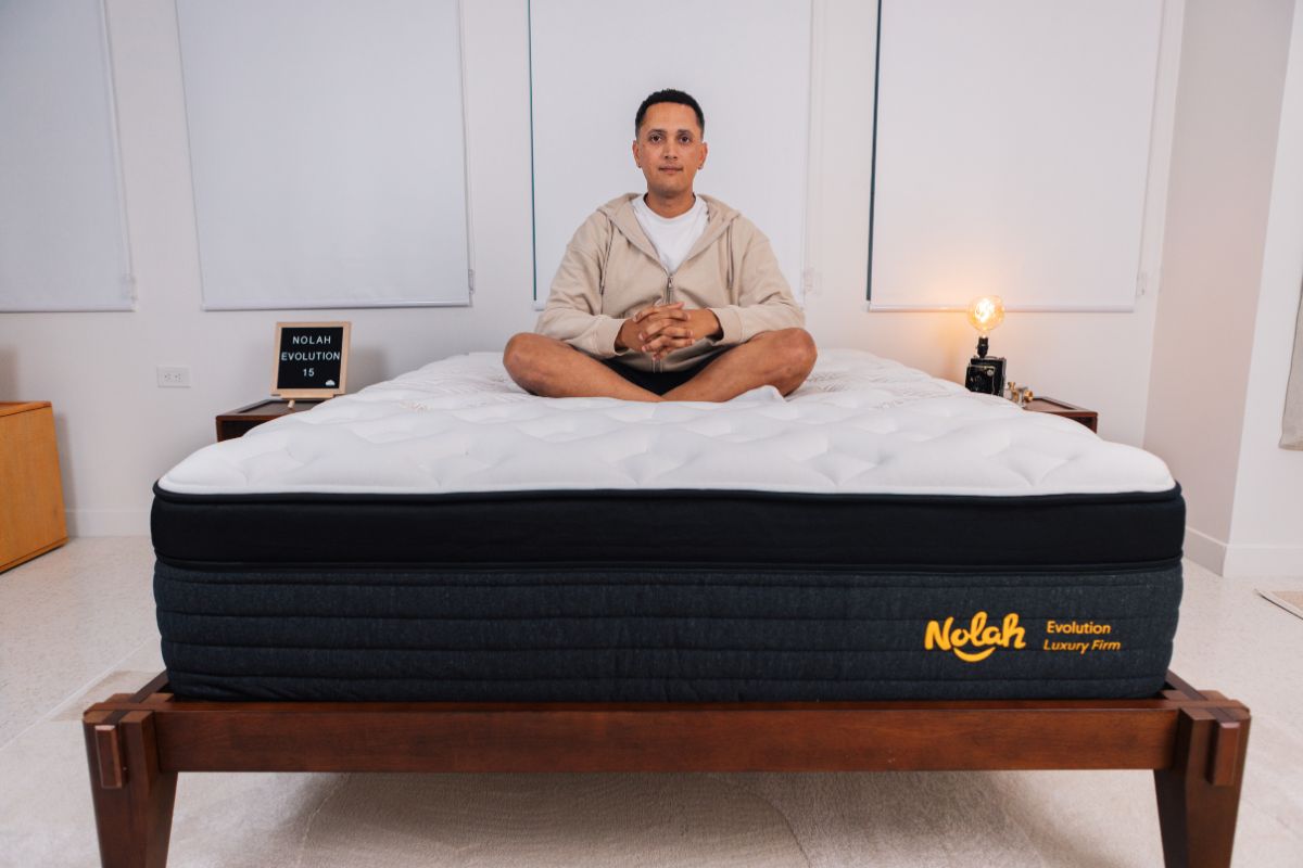 A man wearing comfortable clothes crossed legs on a Nolah Evolution 15".