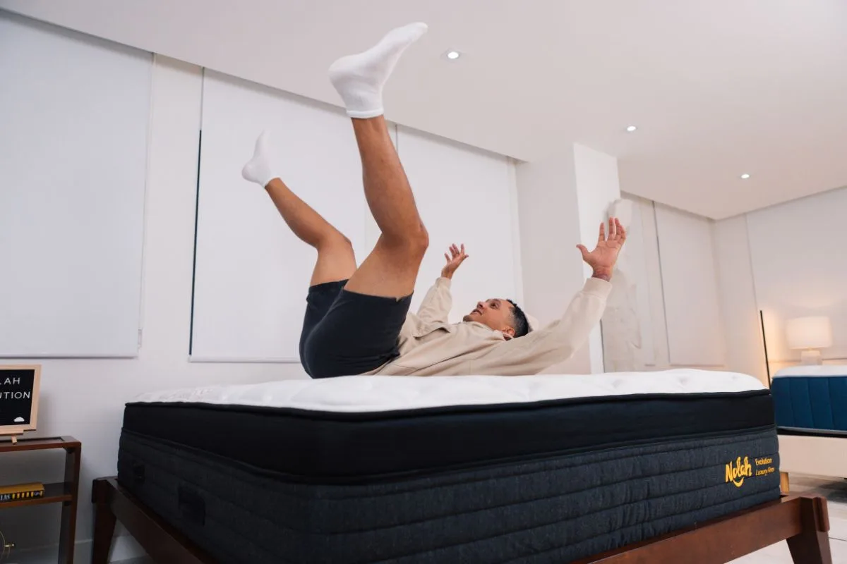 A man wearing comfortable clothes landing on a Nolah Evolution 15