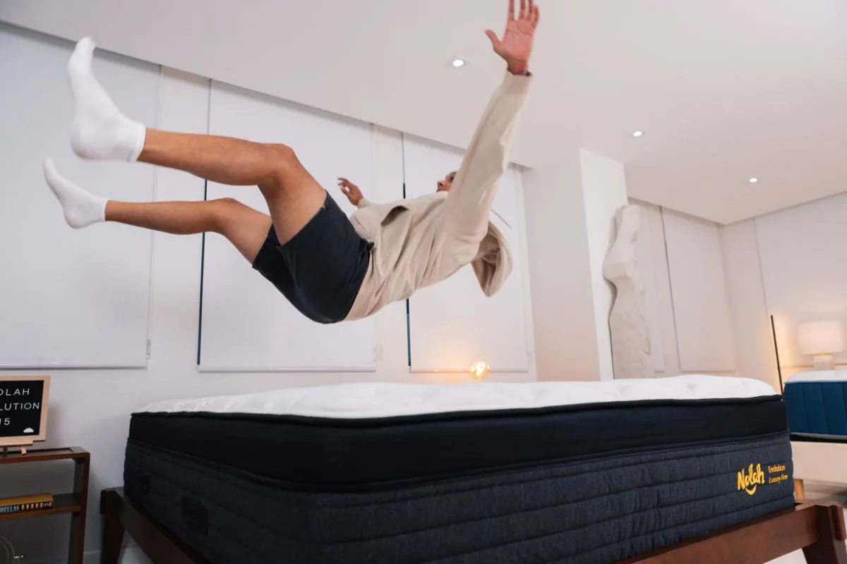A man wearing comfortable clothes landing on a Nolah Evolution 15