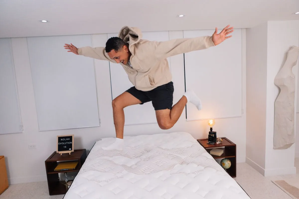 A man wearing comfortable clothes jumping on a Nolah Evolution 15