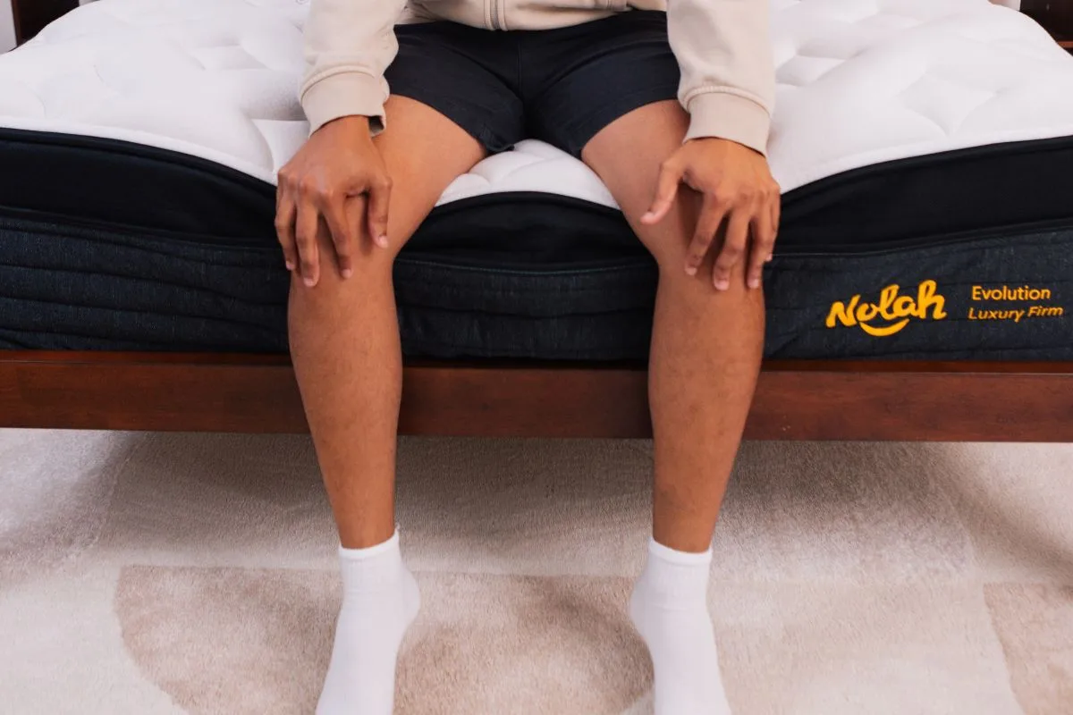 A person wearing comfortable clothes sitting at the edge of the Nolah Evolution 15".