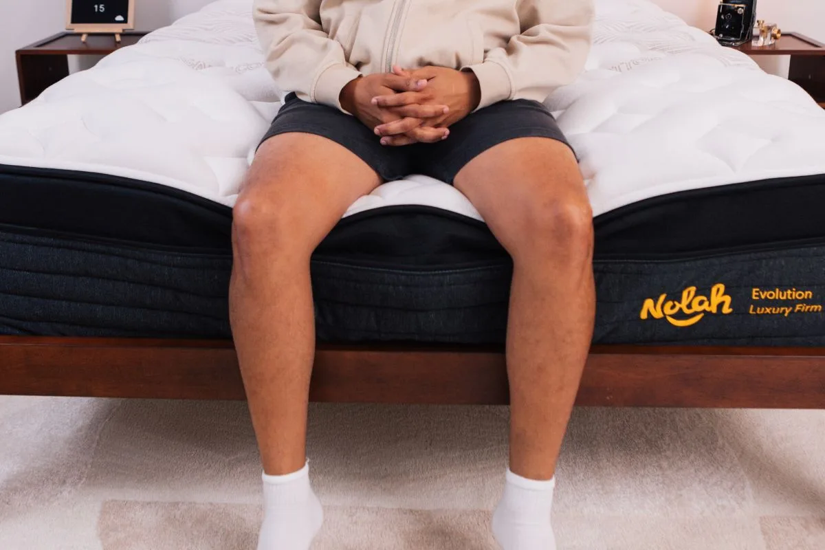 A person wearing comfortable clothes sitting at the edge of the Nolah Evolution 15".