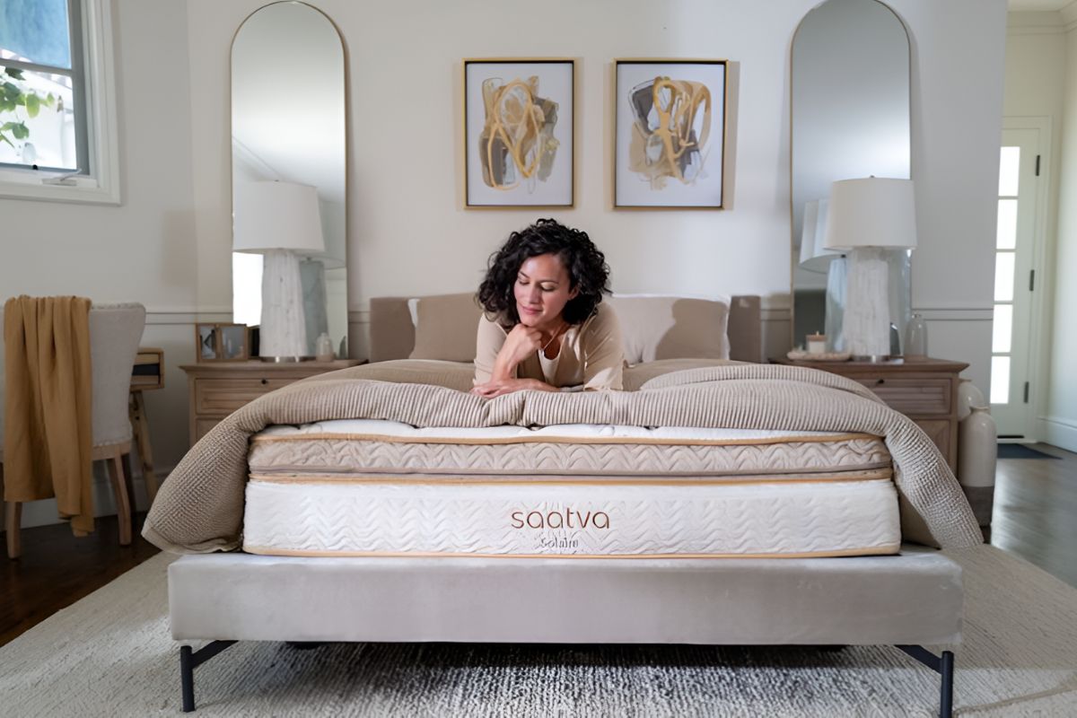 Person lying on adjustable Saatva Solaire mattress demonstrating sleeping position support