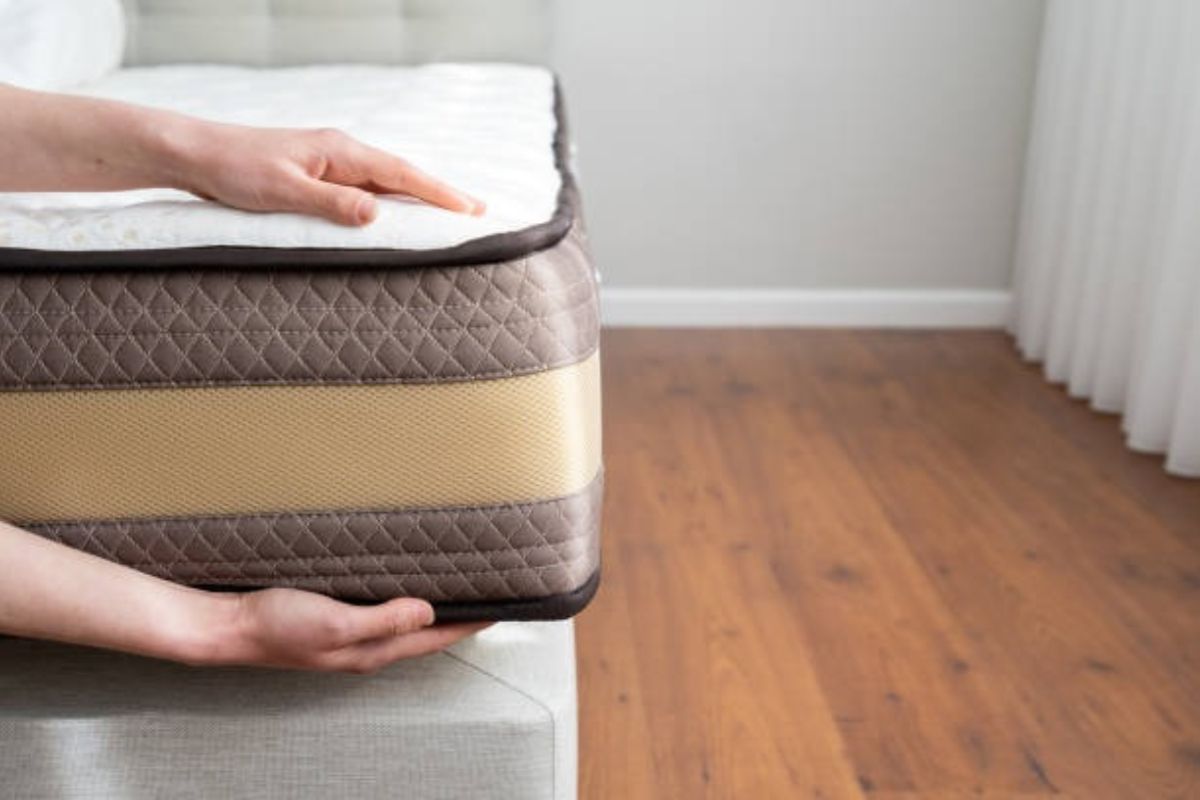 Close-up of a full size mattress corner showing the compact dimensions of a full bed