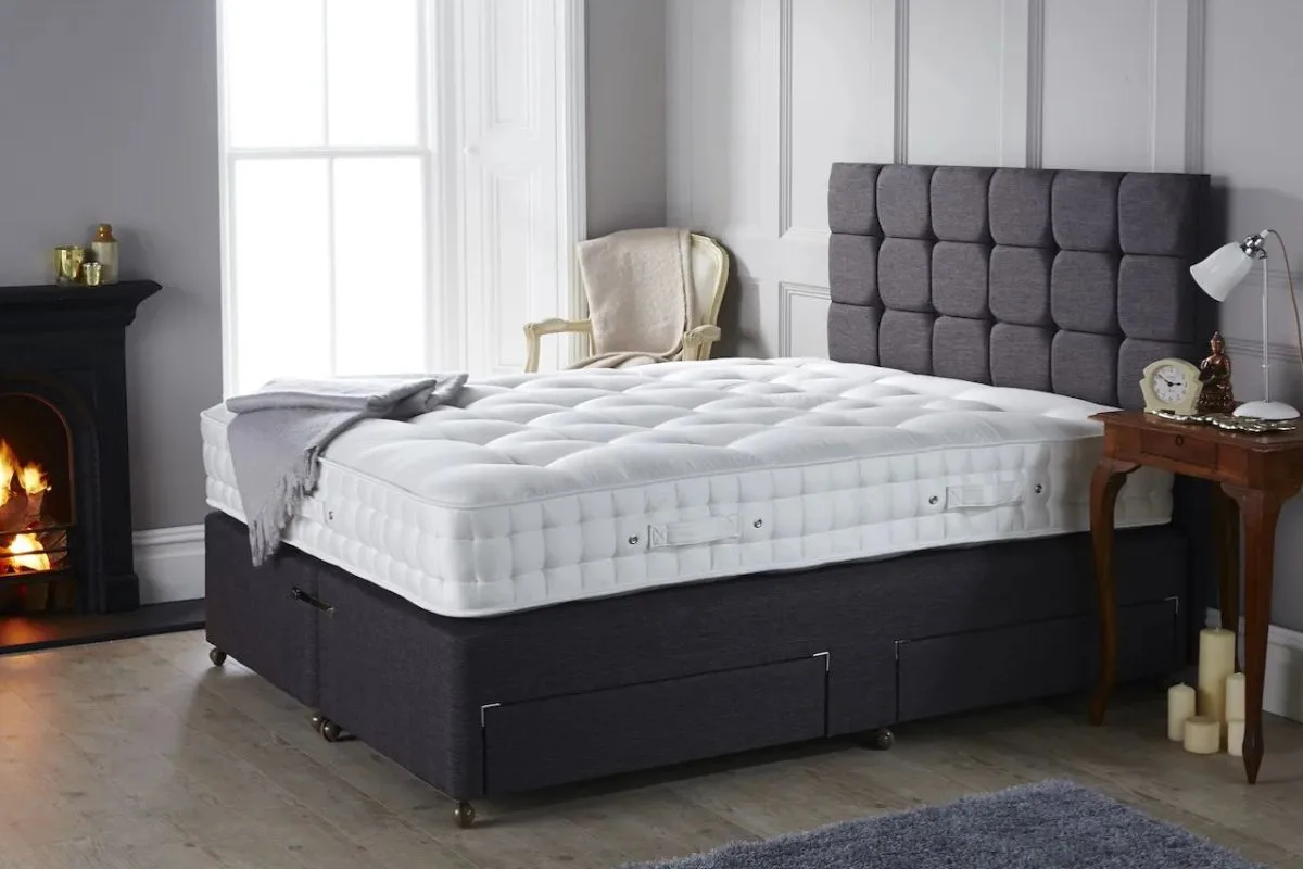 Full size bed with a thick mattress and tall upholstered frame showing overall bed height