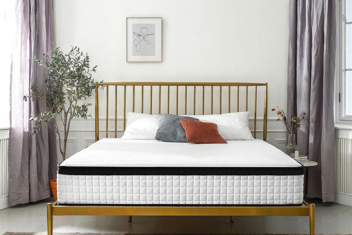 Full XL mattress displayed on a modern gold bed frame in a bright bedroom setting