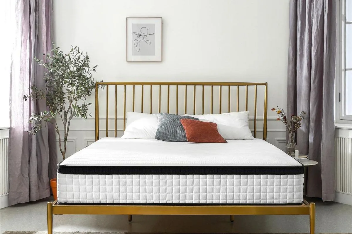 Full XL mattress displayed on a modern gold bed frame in a bright bedroom setting