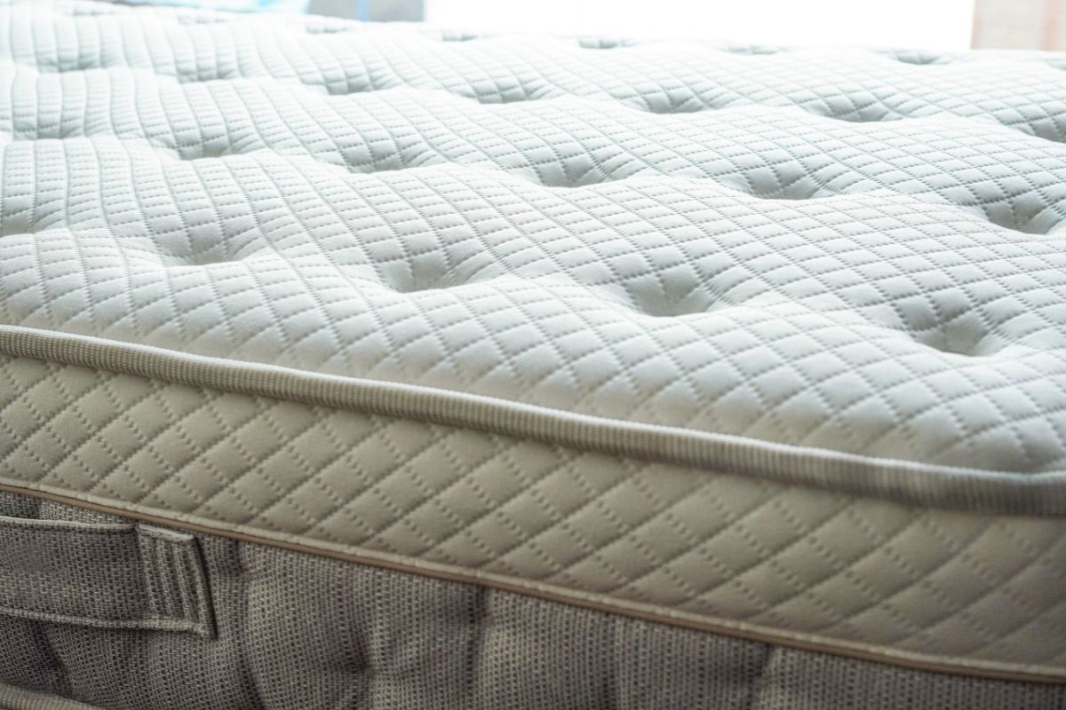 Do Kids Need a Soft or Firm Mattress? Close-up of a quilted mattress surface, representing a supportive sleep surface designed for children’s comfort and spinal development