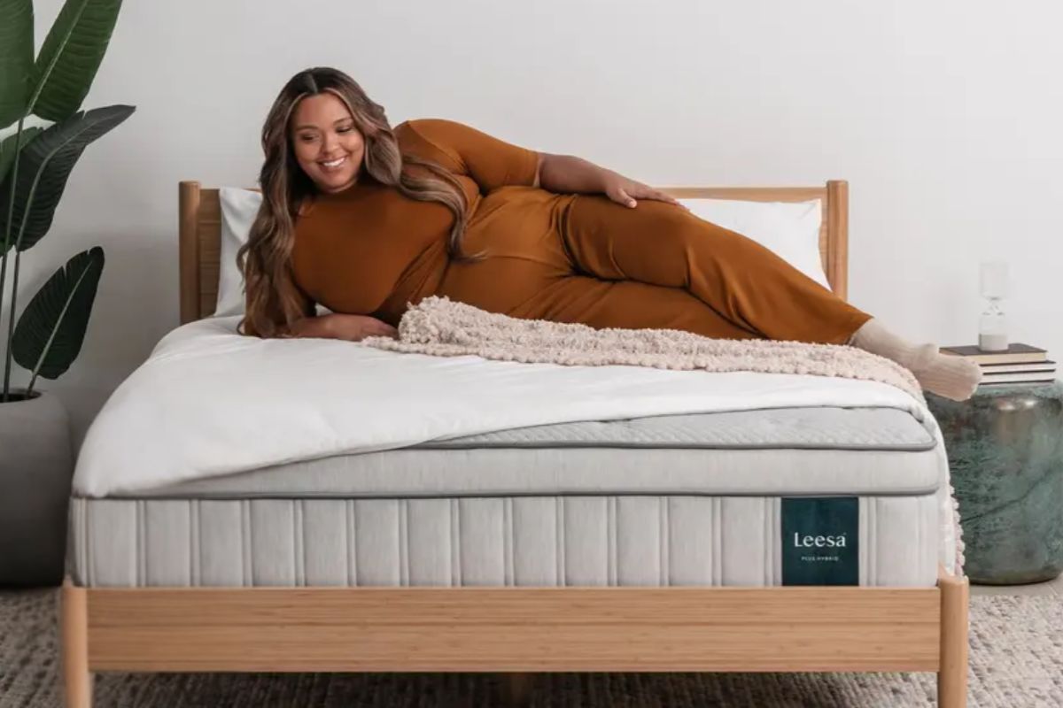 Plus-size sleeper resting on a Leesa Plus Hybrid Mattress, illustrating normal use conditions that align with mattress warranty guidelines