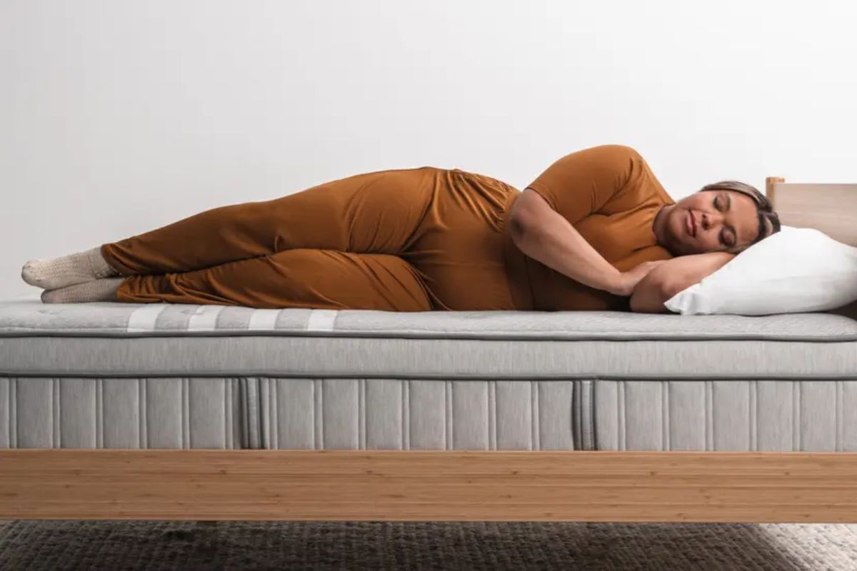 Side sleeper on a Leesa Plus Hybrid Mattress showing proper body alignment and pressure relief, helping explain recommended mattress use for warranty protection