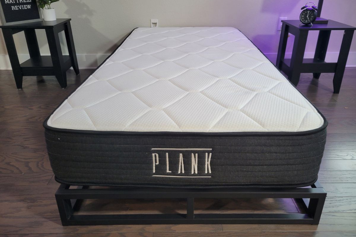 Plank Firm Luxe mattress displayed on a supportive platform bed, illustrating proper mattress setup to help maintain warranty coverage