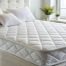 Cooling mattress with a breathable quilted sleep surface designed to improve airflow and help regulate body temperature
