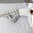 Back sleeper lying on a mattress in a relaxed position, demonstrating proper spinal support and body alignment for back sleepers