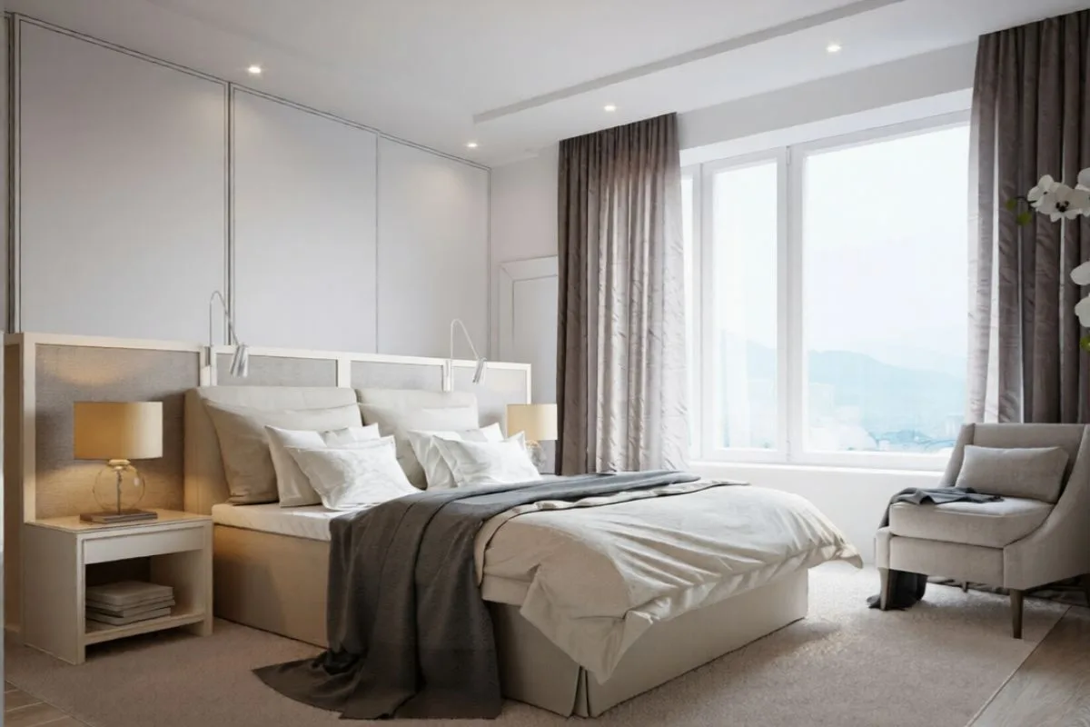 What Mattress Size Is Best for Couples? Large upholstered bed in a bright bedroom, highlighting how mattress size can impact comfort, space, and sleep quality for couples