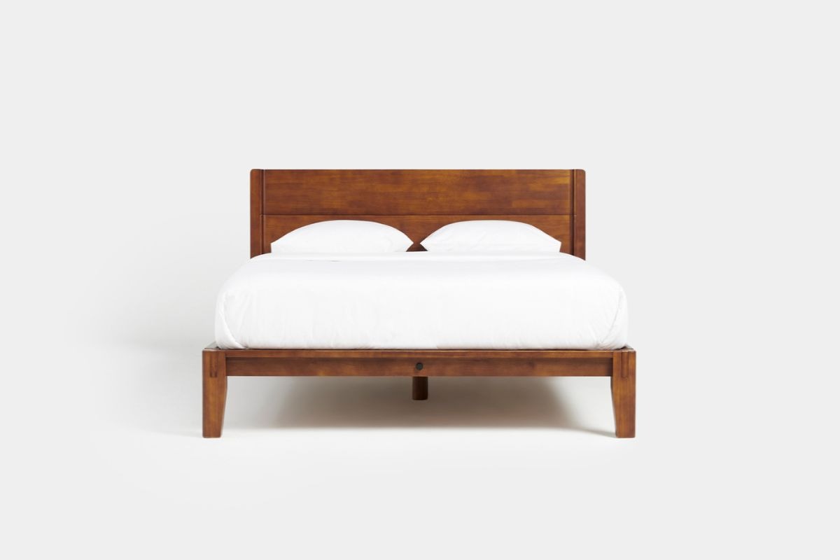 Twin XL mattress on a matching bed frame illustrating the standard dimensions of a Twin XL bed setup
