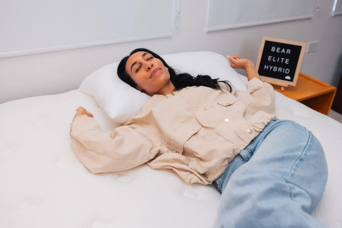 Person relaxing on the Bear Elite Hybrid mattress to demonstrate pressure relief and overall sleeping comfort