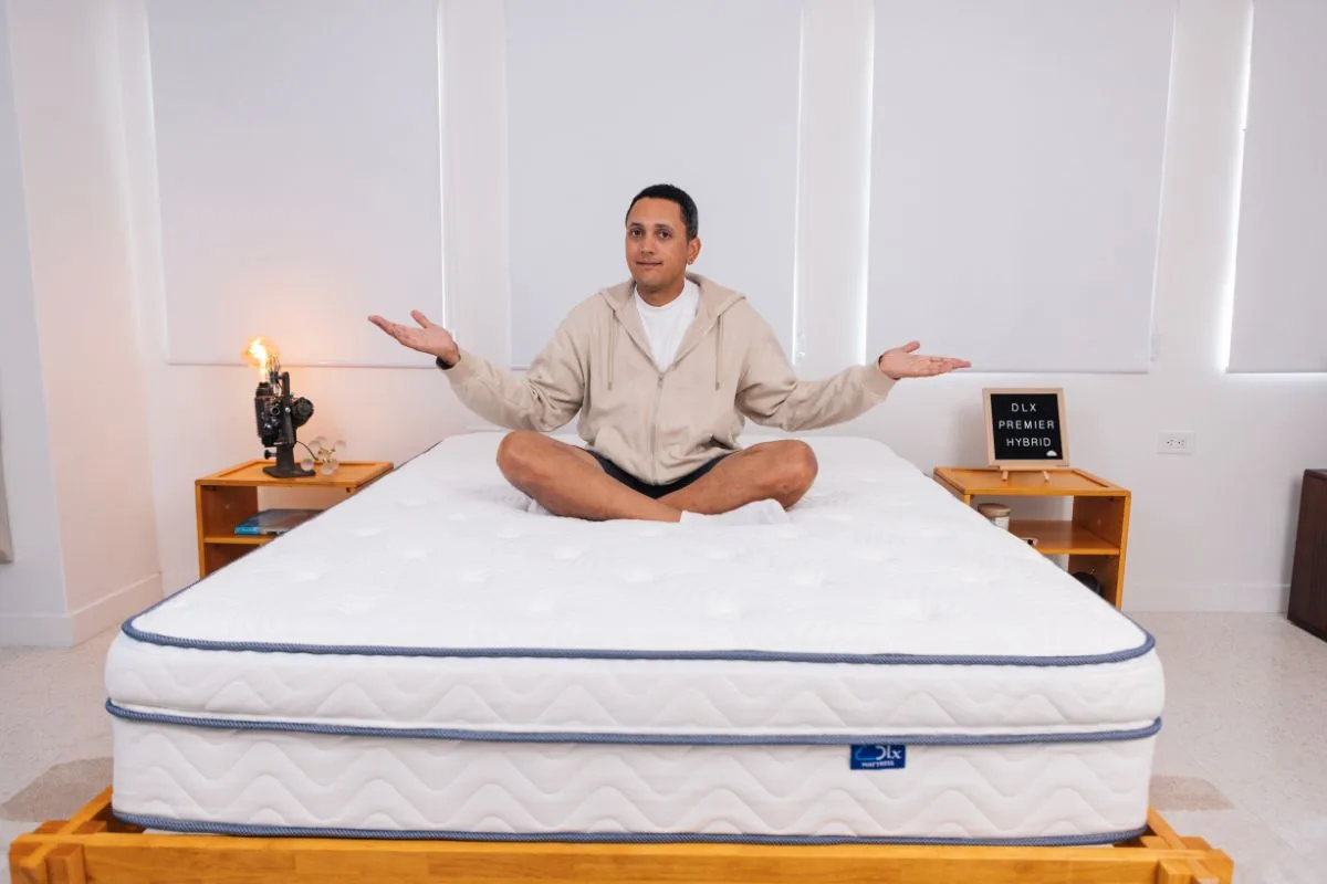DLX Premier Hybrid mattress centered in a bright bedroom with windows