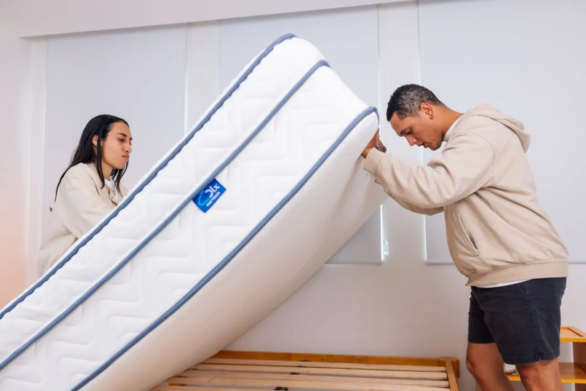 Properly lifting the DLX LatexLux Hybrid mattress during maintenance to prevent damage that could void the warranty