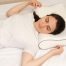 Back sleeper using a medium-loft pillow to maintain proper head, neck, and spinal alignment during sleep